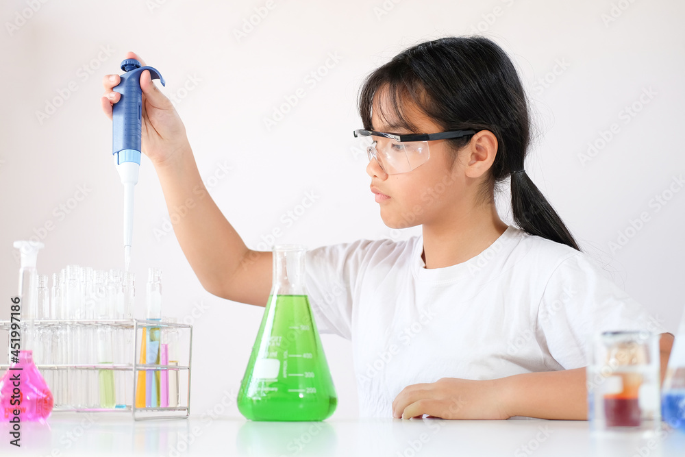Little girl enjoying to examine the colour chemical in laboratory. Science and education. Little girl enjoying to examine the colour chemical in laboratory. Science and education.