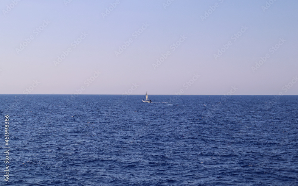 Sailing boat surrounded by blue