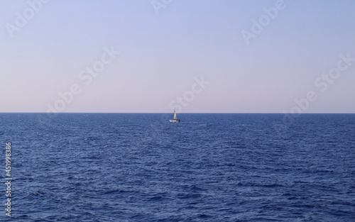 Sailing boat surrounded by blue