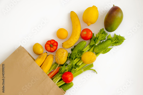 paper bag, vegetables and fruits on a white background