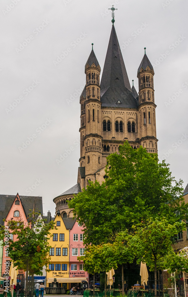 Picturesque view of Cologne's Old Town, including the soaring crossing tower of the Great Saint Martin Church. The quadrangular tower, a landmark, has at each four corners another smaller tower.