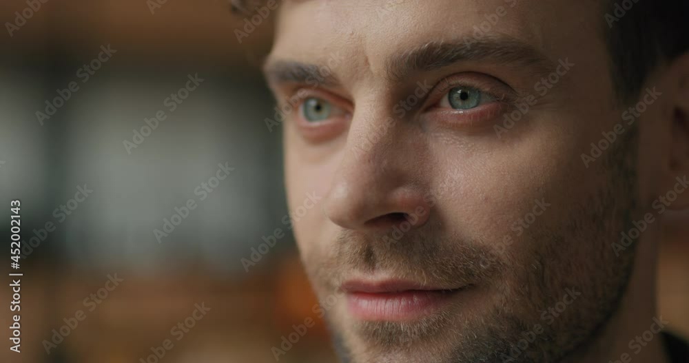 Close-up Face of Attractive Bearded Man with Beautiful Blue Eyes looking ahead. Handsome Male standing indoors Thoughtfully Looking or Dreaming. Successful Guy Freelancer, Entrepreneur. Smart Person. Close-up Face of Attractive Bearded Man with Beautiful Blue Eyes looking ahead. Handsome Male standing indoors Thoughtfully Looking or Dreaming. Successful Guy Freelancer, Entrepreneur. Smart Person.
