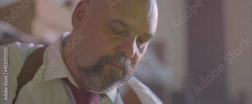 the police chief is sitting in the office and smoking a cigarette