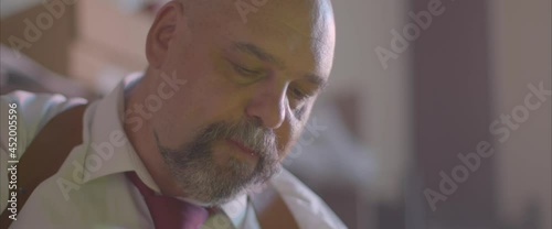 the police chief is sitting in the office and smoking a cigarette