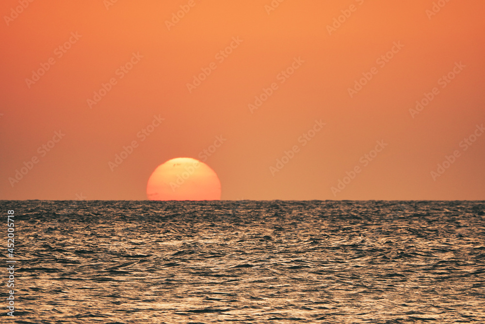 orange sunset over the sea. A great view of the sun over the sea on Imbros island at orange sunset . Gökçeada sunset view