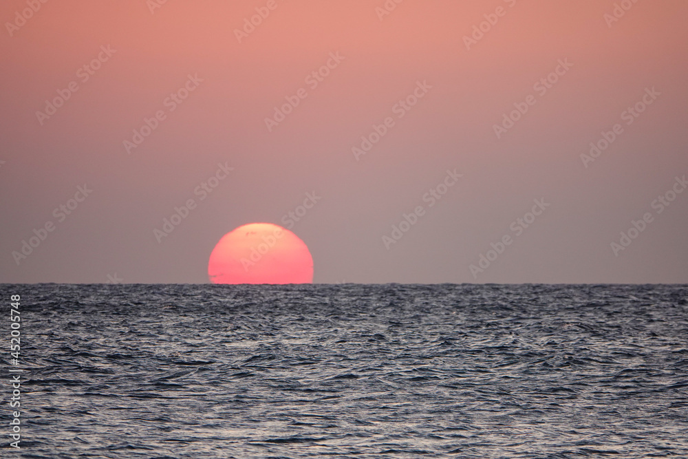 A great view of the sun over the sea on the island at sunset