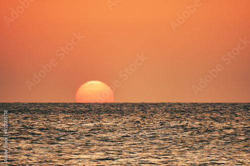orange sunset over the sea. A great view of the sun over the sea on Imbros island at orange sunset . Gökçeada sunset view