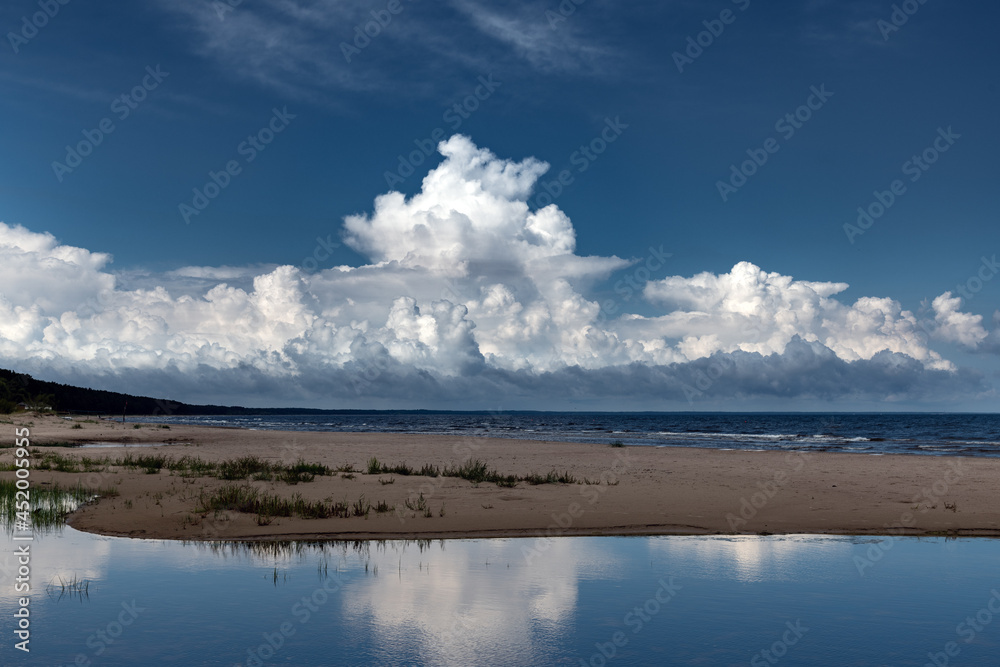 Big cloud over estuary of small river in Gulf of Riga, Baltic sea.