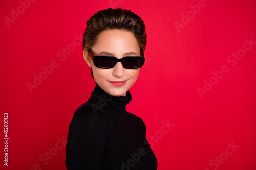Profile side photo of young woman happy positive smile wear eyeglasses isolated over red color background © deagreez