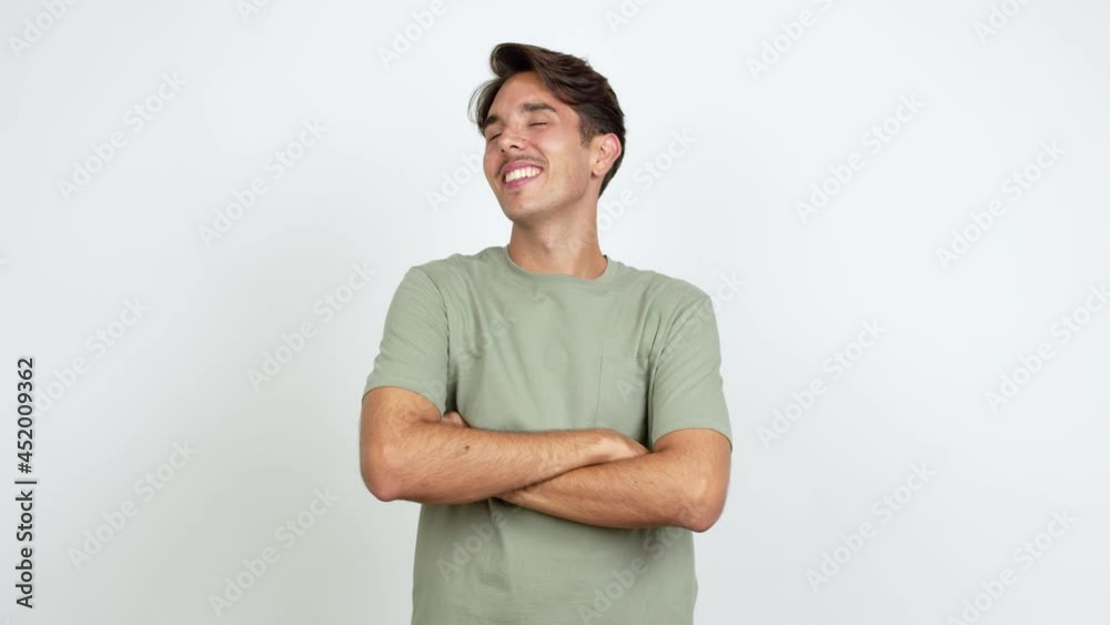 Young man posing with arms at hip and laughing over isolated background Young man posing with arms at hip and laughing over isolated background