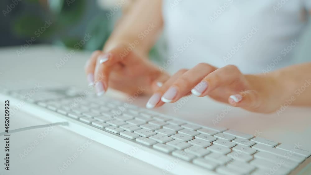 Female hands typing on a computer keyboard. Concept of remote work. Female hands typing on a computer keyboard. Concept of remote work.