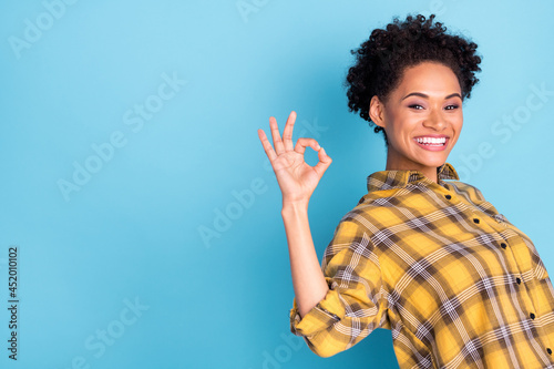 Profile side photo of young afro woman happy positive smile show okay alright sign isolated over blue color background