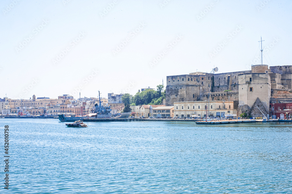 Fototapeta premium destroyer moored in the port of the ancient city of brindisi near the fortress Swabian Castle