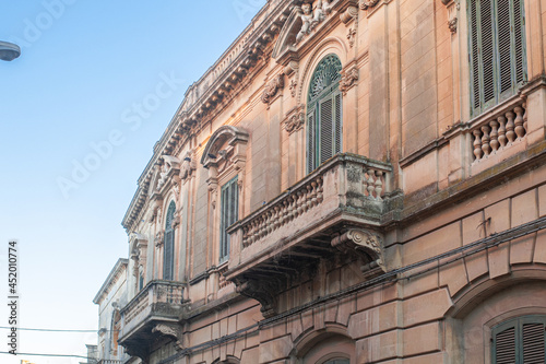 Baroque arched windows and balconies with balustrades of Lecce photo