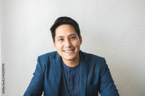 Portrait of happy mature businessman wearing spectacles and looking at camera. Successful middle eastern business man smiling.