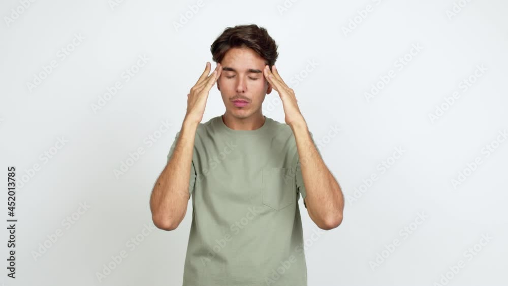 Young man unhappy and frustrated with something over isolated background Young man unhappy and frustrated with something over isolated background