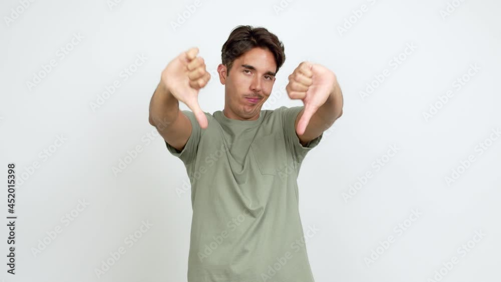 Young man doing bad signal over isolated background Young man doing bad signal over isolated background