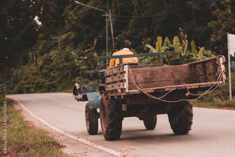 Small tractor running on the street. Tractors used in agriculture in Thailand,country road