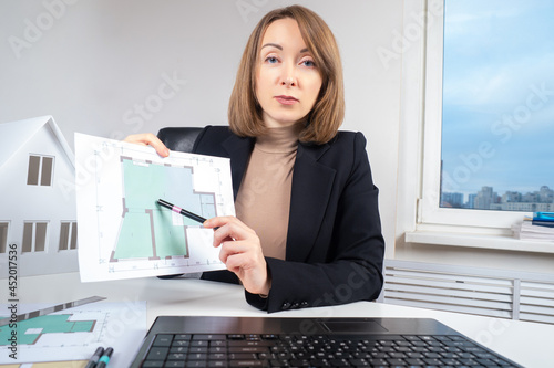 Woman shows the plan of the...