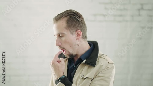 Man disgusted with something and puke at side 4K photo