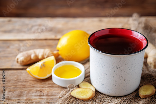 Cup of black tea with honey, lemon and ginger