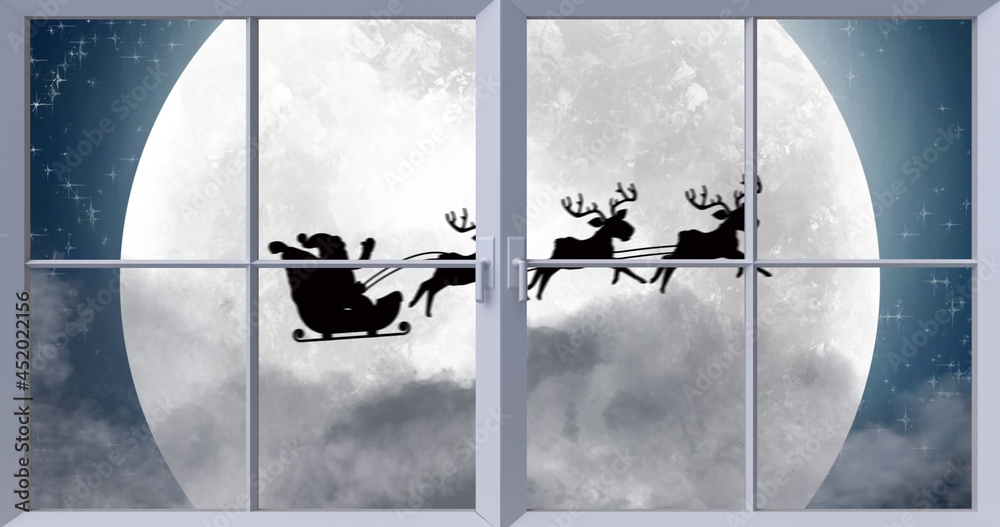 Fototapeta premium Image of black silhouette on santa claus in sleigh being pulled by reindeer with winter scenery 