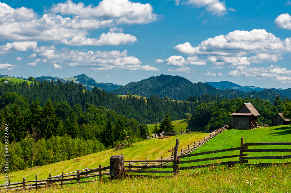 composite summer landscape, fence along the hillside meadows of the mountains. High quality photo composite summer landscape, fence along the hillside meadows of the mountains. High quality photo