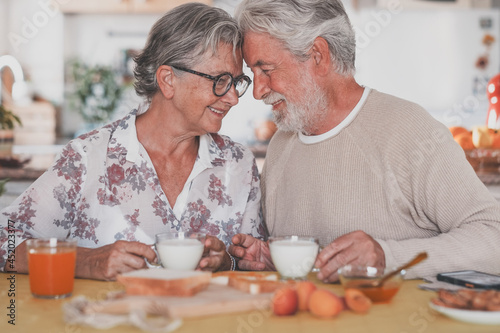 Beautiful senior couple having breakfast at home. Retirement lifestyle
