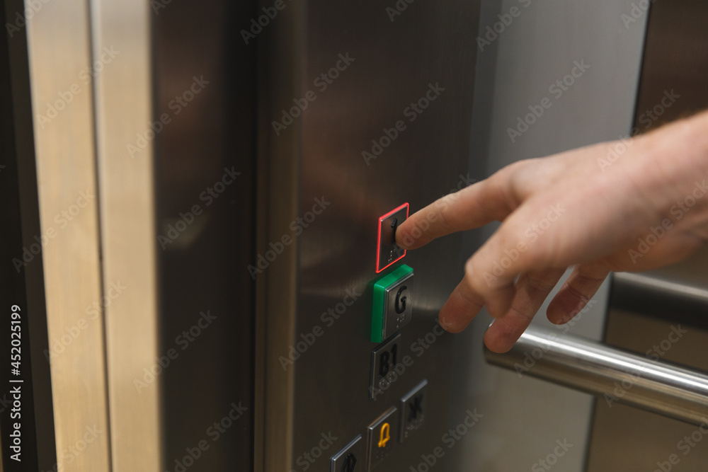 Hand of caucasian male business creative touching buttons in elevator Hand of caucasian male business creative touching buttons in elevator