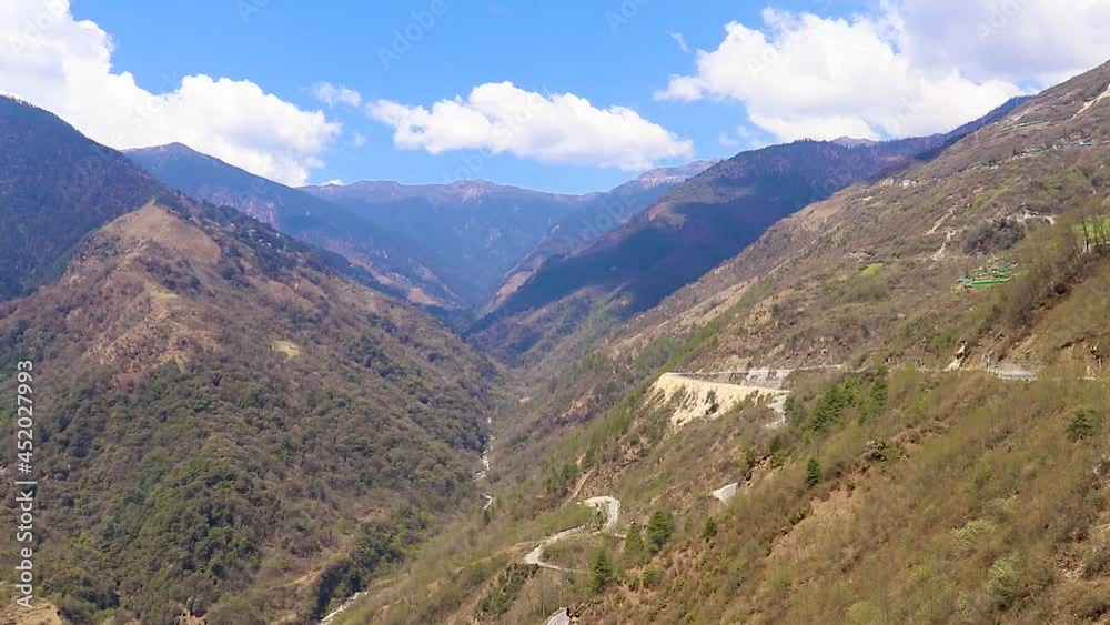 mountain valley with curvy road and bright blue sky at sunny day from top mountain valley with curvy road and bright blue sky at sunny day from top