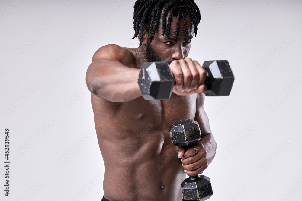 technique of doing an exercise with dumbbell of muscular strong african american sportsman isolated on white studio background, portrait. sport and motivation concept. bodybuilding, fitness technique of doing an exercise with dumbbell of muscular strong african american sportsman isolated on white studio background, portrait. sport and motivation concept. bodybuilding, fitness