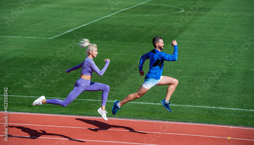 sport couple team in sportswear running on stadium, stamina