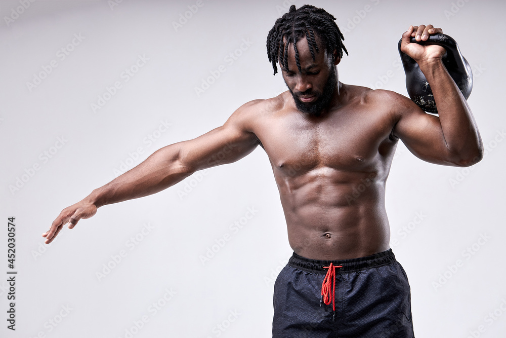 Black afro shirtless man lifting up kettlebell isolated on white studio  background. African Black body builder doing functional training basic  exercise. Bodybuilding, weightlifting, sport, fitness Stock Photo | Adobe  Stock