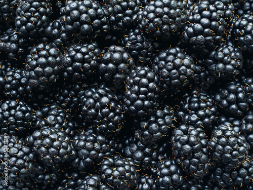 a lot of ripe delicious ripe blackberries close up - food background