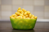 Green plate of Puffcorn on the table