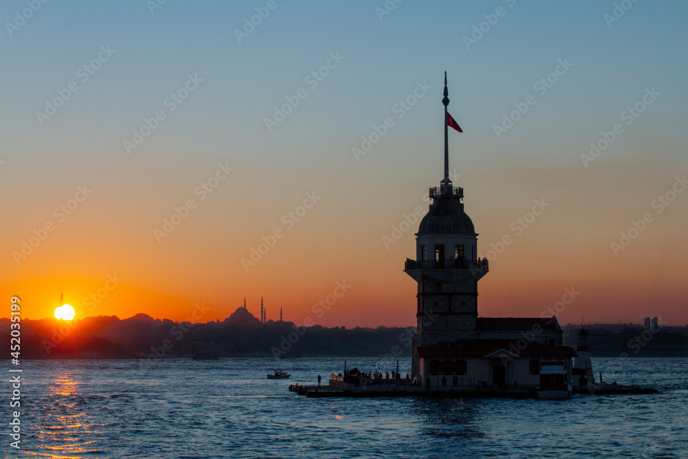 Maiden's Tower in silhouette at the sunset, which was a Byzantine lighthouse on the Bosphorus, Istanbul, Turkey