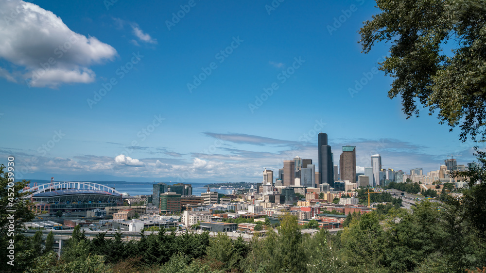 View of Downown Seattle Architecure with Highway and Stadium in the picture