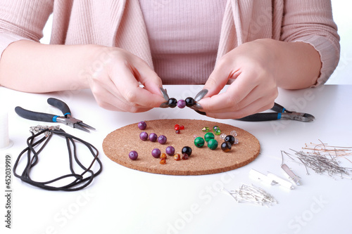 Wallpaper Mural Close-up of female hands. Woman work with jewelry tools on white backgrpound. Jewelry designer working in studio with tools making jewerly. Torontodigital.ca