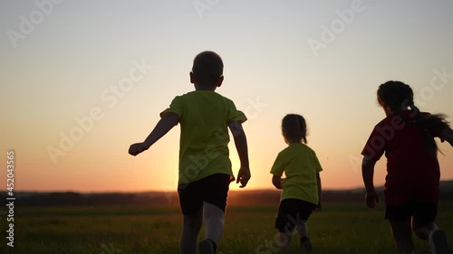 happy family. children kid together run in the park at sunset silhouette. people in park concept. mom dad daughter and son joyful run. happy family and fun little baby child summer kid dream concept photo