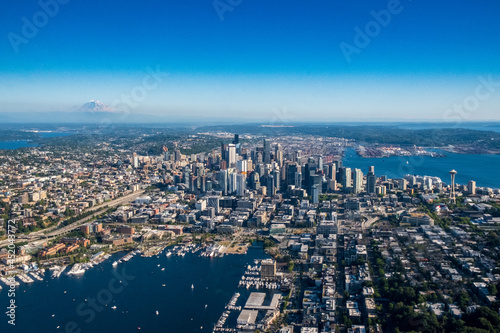 The Seattle skyline and surrounding areas as seen from the air on a clear blue sky day  with Mt. Rainier in the background
