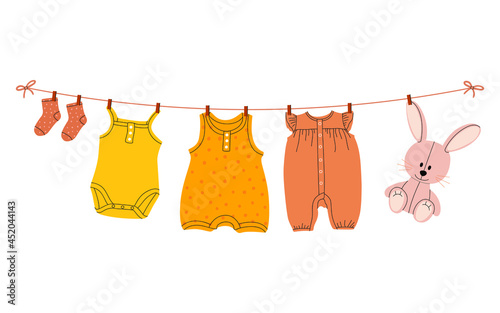 A flat vector cartoon illustration of kids things that are dried on a clothesline using clothespins. Isolated design on a white background.