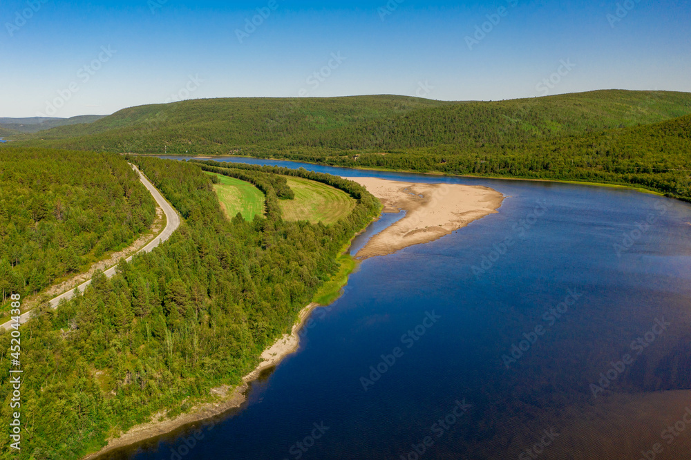 Aerial view of river Karasjohka, sandy beach and forest at the border of Finland and Norway