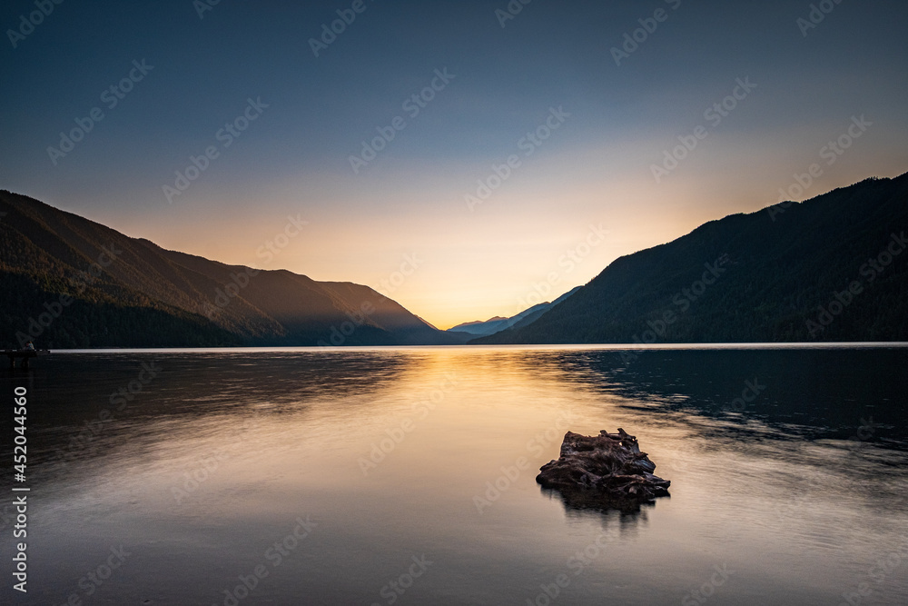 Long exposure of a sunset over Lake Crescent with reflections on the water