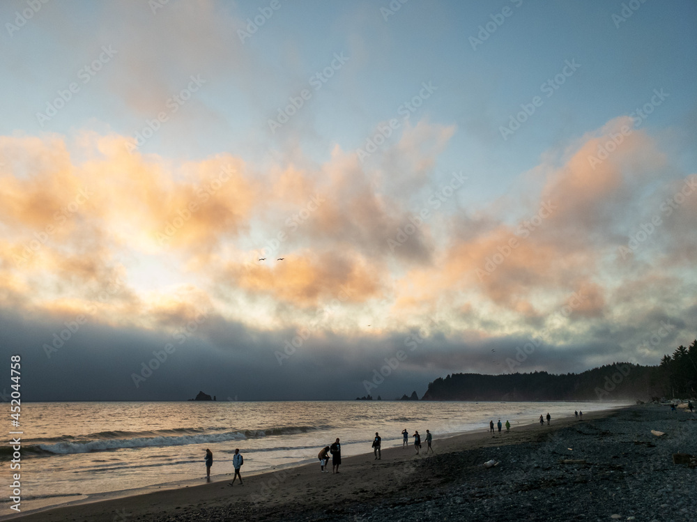 Colorful clouds dot the sky on a cloudy sunset at the beach Colorful clouds dot the sky on a cloudy sunset at the beach