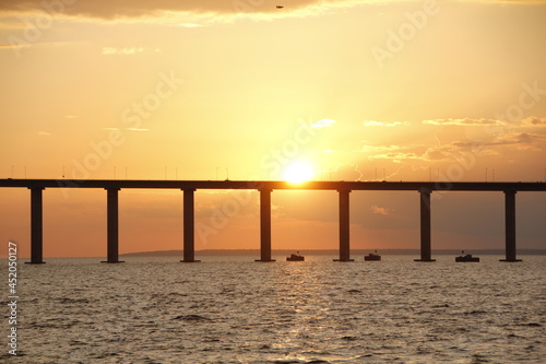 sunset on the black river showing the black river bridge