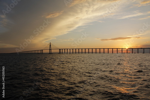 sunset on the black river showing the black river bridge