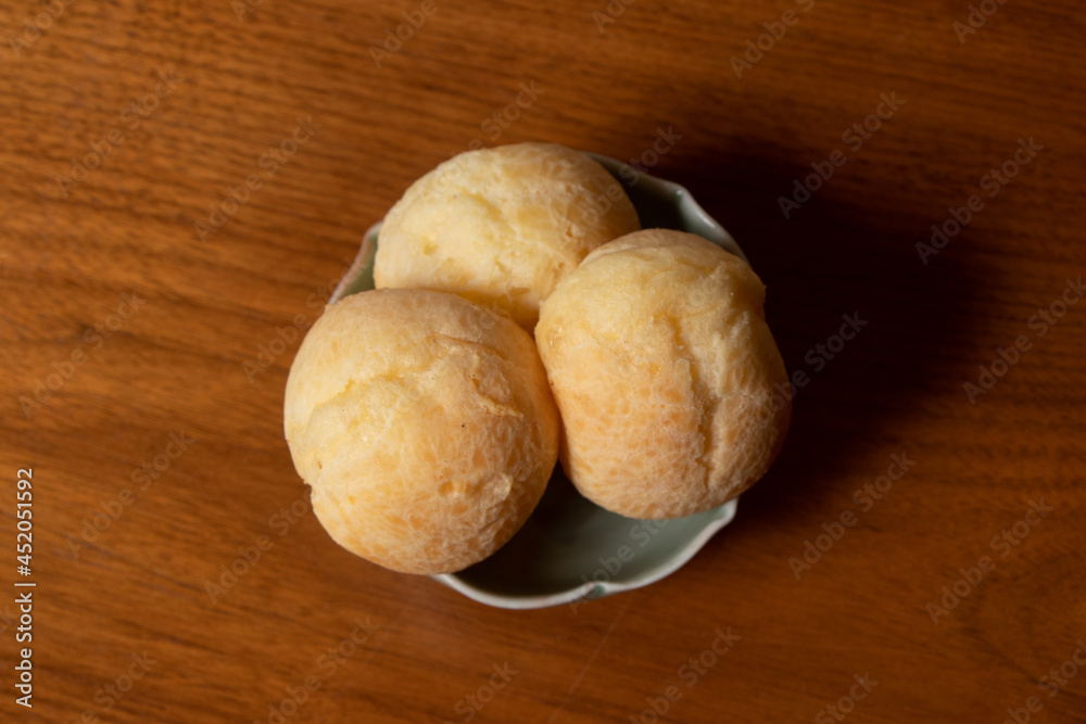 cheese rolls served in white dish on wooden table background, close-up photo and wooden background. cheese rolls served in white dish on wooden table background, close-up photo and wooden background.