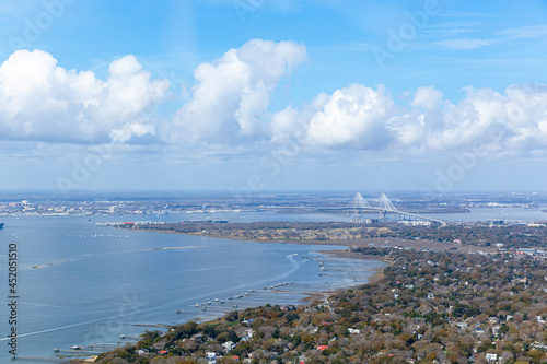 Mt. Pleasant, SC landscape. Arthur Ravenel Jr. Bridge in background. Docks extending into the ocean and beautiful clouds in the sky.