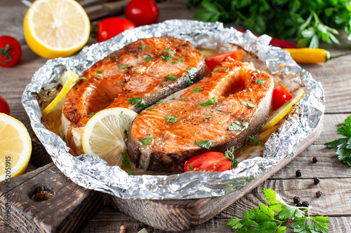 Photography Grilled salmon fish with seasoning and various vegetables on table