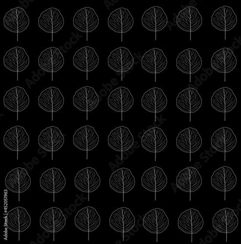 Autumn leaf background with white leaf outlines on black background. Leaves are in rows and columns. Fall, seasonal.